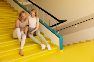 Nightingale Health – women sitting on the stairs.